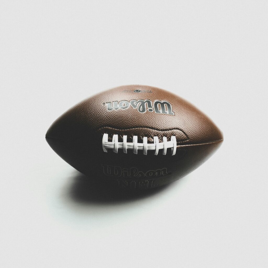 Close-up of a Wilson NFL football against a white backdrop, showcasing its texture.